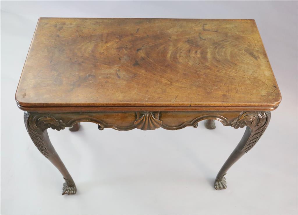 A mid-18th century Irish carved walnut folding top card table, W.2ft 9in. D.1ft 4in. H.2ft 5in.